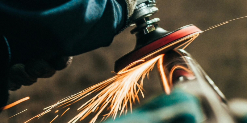 Angle grinder cutting metal with sparks