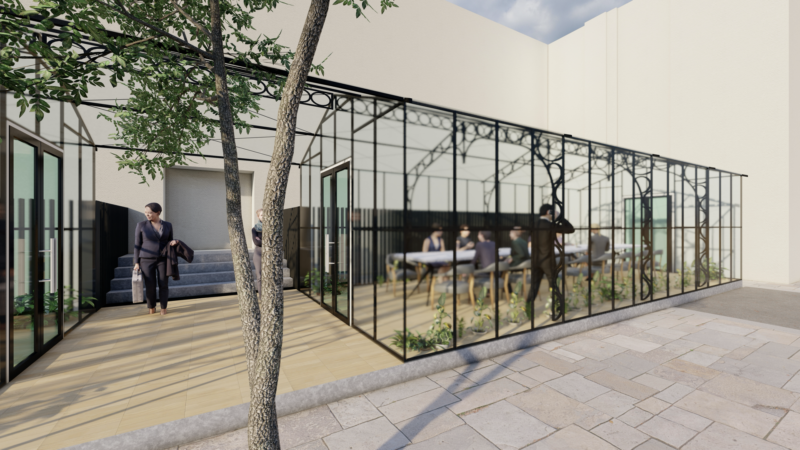 Modern glass-walled office building with outdoor courtyard
